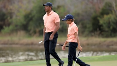 Tiger Woods and Charlie Woods walk off the 14th hole. AFP
