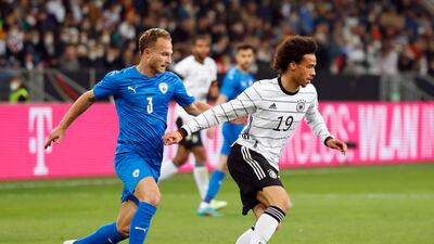 Israel's Dan Glazer attempts to challenge Germany forward Leroy Sane. Reuters