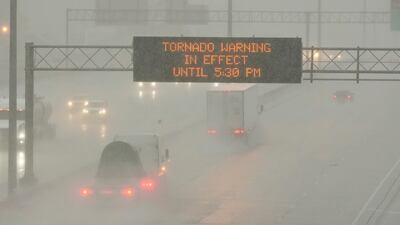 The Mississippi Department of Transport digital message board warns drivers along I-55 southbound in Jackson of a tornado warning during a rainstorm during the outbreak of severe weather in the state on Wednesday, March 30, 2022. AP