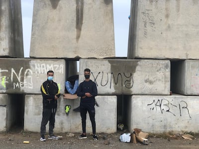 Yahya Aarab (left), 25, from Tangier and Yassine Yerrou, 17, from the northern Morocco city of Tetouan sleep on Ceuta's sea defences. Karen Rice
