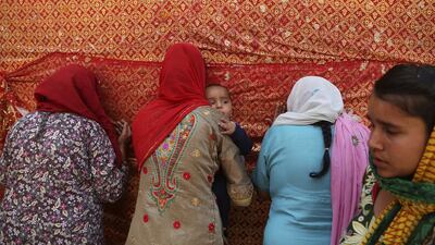 Hindu devotees pray outside the Kali Temple during the Navratri festival in Jammu, India. AP