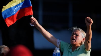 A supporter of opposition leader and self-proclaimed interim president Juan Guaido, holding a Venezuelan flag, cheer him on during a rally in a west side neighbourhood in Caracas, Venezuela, Friday, April 5, 2019. AP
