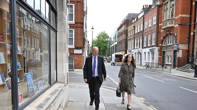 Former ministers Conservative MPs Chris Grayling (L) and Theresa Villiers (R), members of the British parliament's intelligence and security committee, leave the committees offices in central London on July 16. AFP