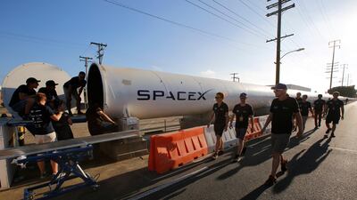 Members of the WARR team from Technische Universitat Munchen walk to the end of the SpaceX's Hyperloop track to retrieve their winning pod in Hawthorne, California,. The WARR team from the university won the competition with a peak speed of 324 kilometers per hour (201 mph). Damian Dovarganes / AP Photo