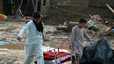 People salvage their belongings after flash floods in Kandahar, Afghanistan on March 2, 2019. EPA