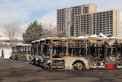 Parked buses that were burnt at a depot during public protests in Tehran. AFP