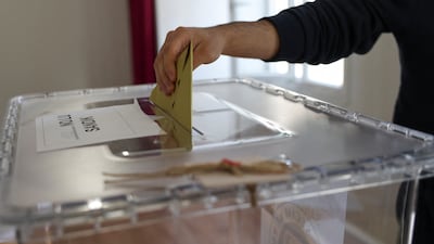 A voter casts a ballot at a polling station in Hatay. Reuters