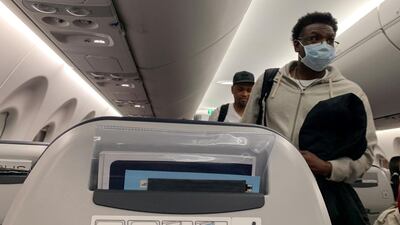 A passenger wears a protective mask on an EgyptAir flight from Cairo to Luxor, Egypt March 9, 2020. Reuters