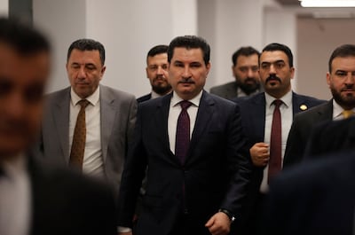 Shakhwan Abdullah, centre, the candidate for deputy speaker of the Iraqi Parliament, enters the parliament hall in Baghdad's Green Zone. AFP