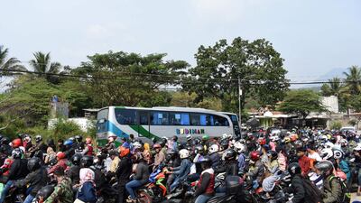 Indonesian motorists travel along a road in Garut, West Java as people return to their hometowns to celebrate Eid Al Fitr. AFP