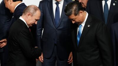 Mr Putin and Mr Xi prepare for a the G20's family photo. EPA