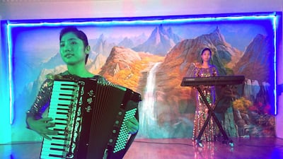 Korean waitresses play music at the Pyongyang Okryu-Gwan, a North Korean Restaurant in Abu Dhabi. AP Photo / Kamran Jebreili
