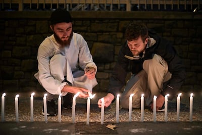 Well-wishers light 49 candles as they pay respects to victims outside the hospital in Christchurch. AFP