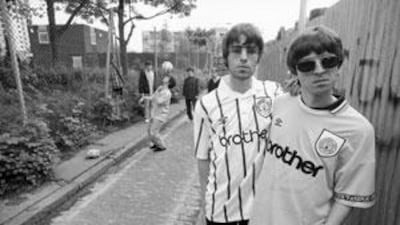 Singer Liam Gallagher, left, and his brother Noel, of rock band Oasis, sport their Manchester City football shirts in 1994.