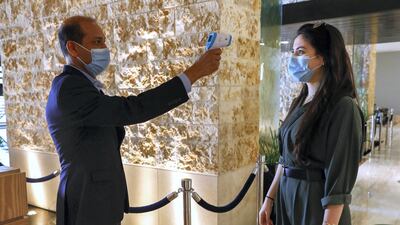 Restaurant guests have their temperature checked before entering the premises.