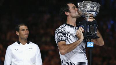 Roger Federer kisses the trophy after winning the Australian Open. Issei Kato / Reuters