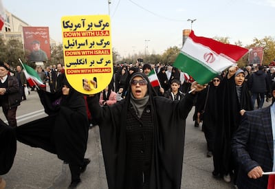 An Iranian woman holds a placard condemning the US, UK and Israel after the explosions in Kerman, on January 5. ISIS claimed the attack. EPA