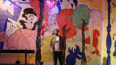 Emirati artist Khalid Mezaina stands with his artwork created especially for the exhibition. Pawan Singh / The National