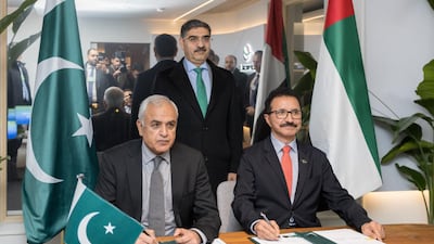 Shahid Ashraf Tarar, Pakistan’s Federal Minister of Communication, Railways and Maritime Affairs, left, and Sultan bin Sulayem, chairman of Dubai's Ports, Customs and Free Zone Corporation, sign agreements at Davos, Switzerland. Photo: DP World