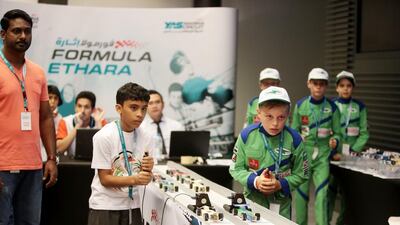 Ross Parsons, 10, right, of Team Thunder Street, from Jess AR school in Dubai, competes during the Formula Ethara national finals, a model racing car competition, at Yas Marina Circuit in Abu Dhabi. Christopher Pike / The National