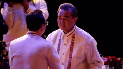 China's foreign minister Wang Yi, right, shakes hands with Philippine foreign secretary Alan Peter Cayetano during the gala dinner of the Association of South-East Asian Nations Foreign Ministers Meeting (AMM) and Related Meetings in Manila, on August 6, 2017. Mark R Cristino / AFP