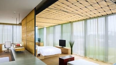 Like all rooms at the Opposite House, the penthouse has floor-to-ceiling windows.