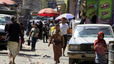 Yemenis walk through a market in Sanaâ. EPA