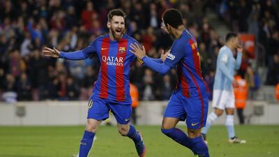 Barcelona’s Lionel Messi, left, celebrates with teammate Neymar after scoring the opening goal against Celta. Francisco Seco / AP Photo
