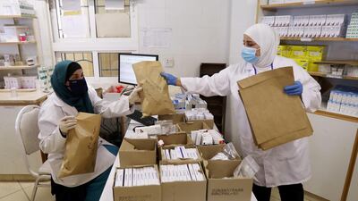 Medical staff at UNRWA pack prescriptions for delivery to the homes of Palestinian refugees at Al Wehdat camp near Amman, Jordan. Reuters