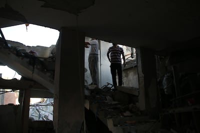 Palestinians search for survivors in buildings hit by Israeli air strikes in Khan Younis, south of the Gaza Strip, on Saturday. Getty Images