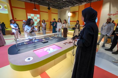 Interactive displays sit alongside rare artefacts in A Board Game Adventure at Louvre Abu Dhabi. Victor Besa / The National