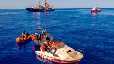 Three small rescue boats that are part of the Sea-Watch 4 civil sea rescue ship approching he pink rescue boat "Louise Michel" off the coast of Libya. British street artist Banksy is funding the Louise Michel, covered with his own artwork, to rescue migrants in the Mediterranean. AFP