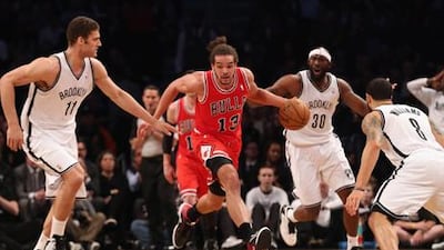 Joakim Noah looks for a way through the Brooklyn defence during their NBA playoff match.