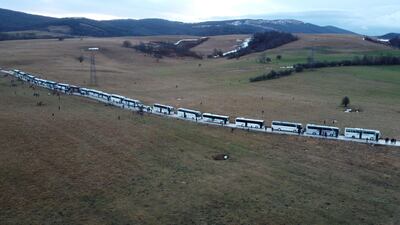 Hundreds of migrants wait in busses after camp Lipa was closed. Reuters