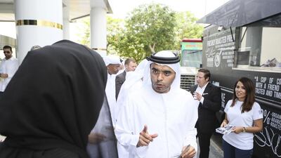Majid Saif Al Ghurair, CEO of Al Ghurair Group and chairman of the Dubai Chamber of Commerce, tours various food truck concepts in the parking lot of Dubai Chamber of Commerce. Sarah Dea / The National