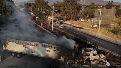 Smoke rises from a burnt lorry on a motorway in Mexico's Jalisco state, after the killing of drug lord El Mencho caused widespread violence. AFP