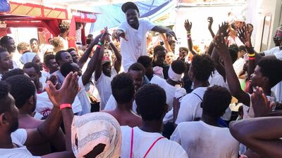 Migrants celebrate aboard the 'Ocean Viking' rescue ship as six EU countries agreed to take them in after 14 days at sea.. AFP