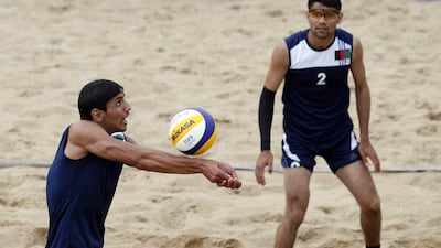 Afghanistan's Pardes Safi, left, and Mohammad Zaker, right, play a return during one of their preliminary matches in beach volleyball at the Asian Games. Olivia Harris / Reuters / September 24, 2014
