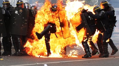 French CRS anti-riot police officers are engulfed in flames during May Day clashes in Paris. Zakaria Abdelkafi / AFP Photo / May 1, 2017