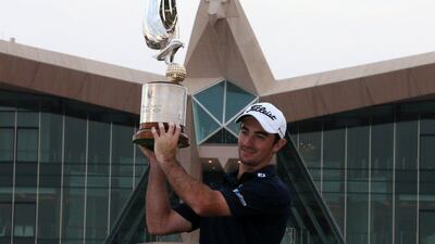 Gary Stal of France poses with the Falcon trophy after winning the Abu Dhabi HSBC Golf Championship on January 18, 2015. Karim Sahib/AFP