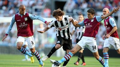 Newcastle United's captain Fabricio Coloccini, center, vies for the ball with Aston Villa's Matthew Lowton, right, and Karim El Ahmadi, left, during their English Premier League soccer match at the Sports Direct Arena in Newcastle, England on September 2, 2012. Scott Heppell / AP Photo
