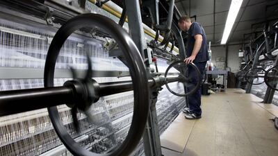 A worker makes checks on one of the old traditional looms built in the UK at the Sophie Hallette lace making factory in Caudry, Northern France.