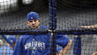 Kansas City Royals third baseman Mike Moustakas looks through the netting as a teammate takes batting practice during a workout on Monday ahead of Tuesday's Game 6 of the World Series. Jeff Roberson / AP / October 27, 2014