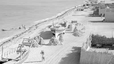 Stacks of coral dry on the beach in Abu Dhabi in the mid-twentieth century. Coral stone was used in the construction of many of the country's historic buildings, including Qasr Al Hosn. Courtesy BP Archive