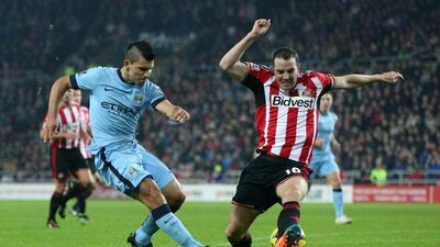 Manchester City's Sergio Aguero plays the ball past Sunderland defender John O'Shea during his side's 4-1 Premier League victory on Wednesday. Ian MacNicol / AFP / December 3, 2014