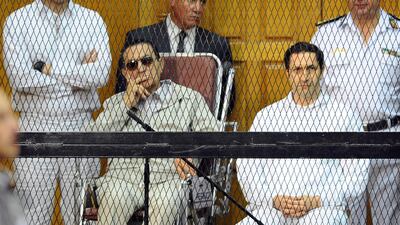 Former Egyptian President Hosni Mubarak, seated centre left, and his two sons, Gamal Mubarak, left, and Alaa Mubarak attend a hearing in a courtroom in Cairo, Egypt. AP