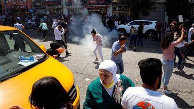 Demonstrators react to tear gas during clashes with Palestinian security forces at a protest following the death of Nizar Banat. Reuters