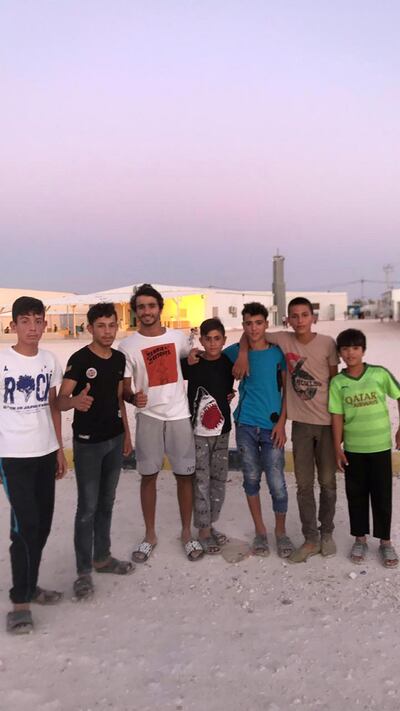 Abdulla Al Hashimi - third from right – with refugees at the the UAE-run Mrajeeb Al Fhood camp in Jordan
