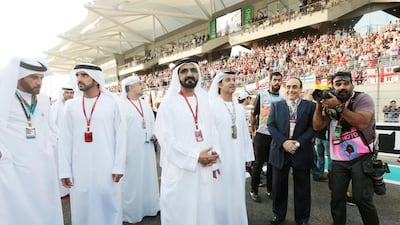 Sheikh Mohammed bin Rashid, Vice President and Ruler of Dubai, walks through the grid ahead of the Abu Dhabi Formula One Grand Prix at Yas Marina Circuit. Christopher Pike / The National