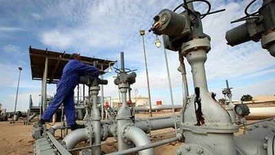 A worker checks pipes and valves at Amaal oil field in Libya. The country is planning to return to pumping oil at pre-2011 revolt levels. Ismail Zitouny / Reuters